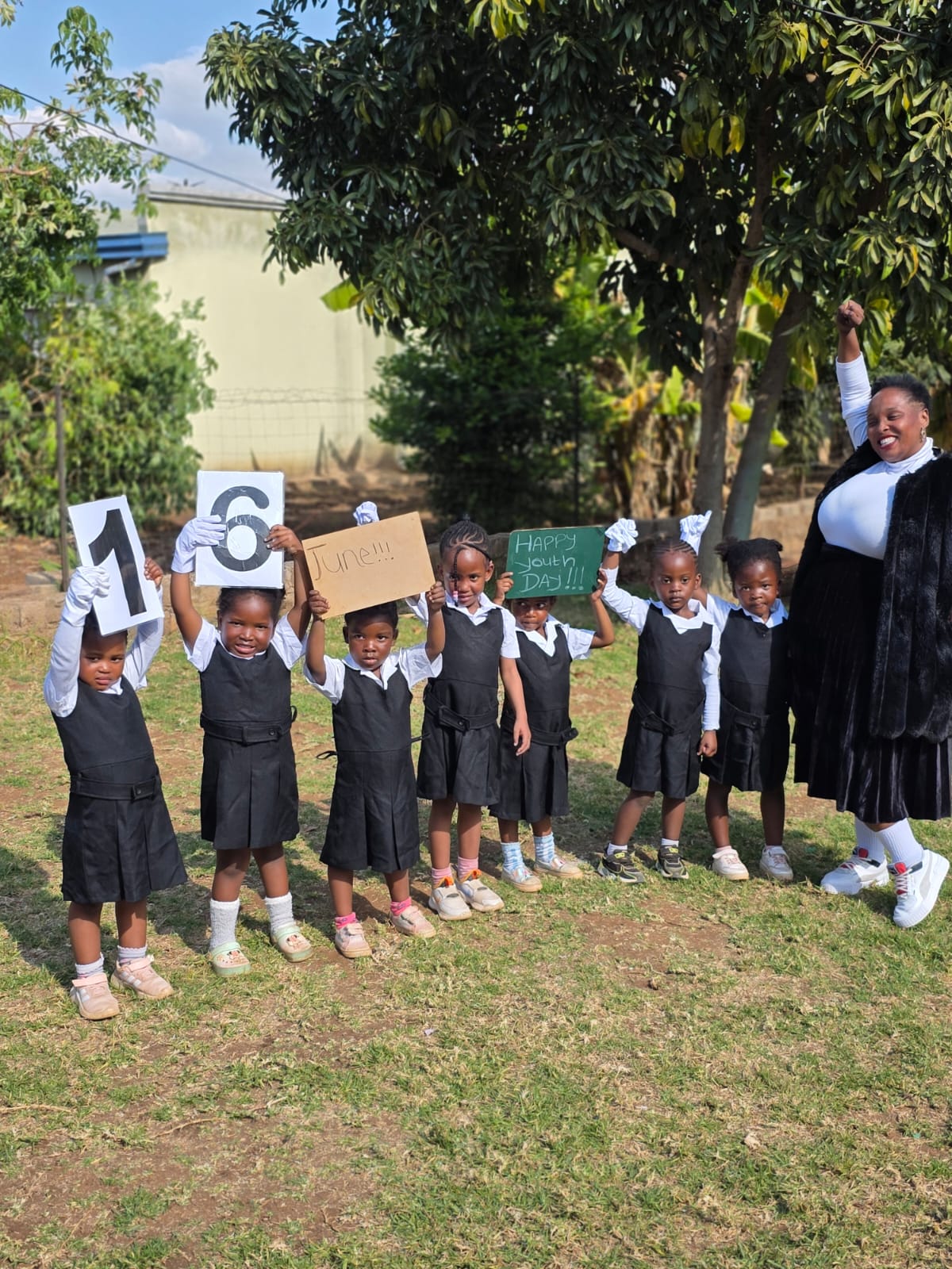 Children and their teacher outside at the creche on Youth Day