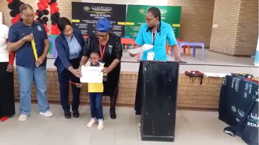 A child receiving a certificate at a school event